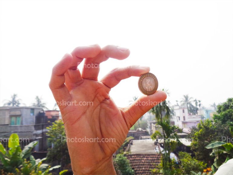 Man Holding A Indian Ten Rupees Coin