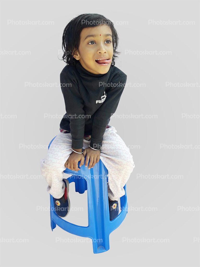 DG00024917, baby, child, Indian little girl, photoskart, photoskart.com, a little girl set on chair, cute girl, Signature, Tanisha Ghosh, child girl wear black dress, black dress child, child girl & black dress, Indian child girl wears a black dress, cute child girl, child with black dress, naughty child, Indian naughty child, Indian little girl sitting on a chair with funny face,