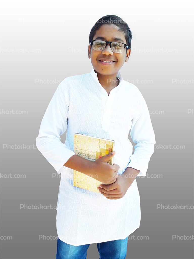 An Indian Boy Smiling And Holding A Book