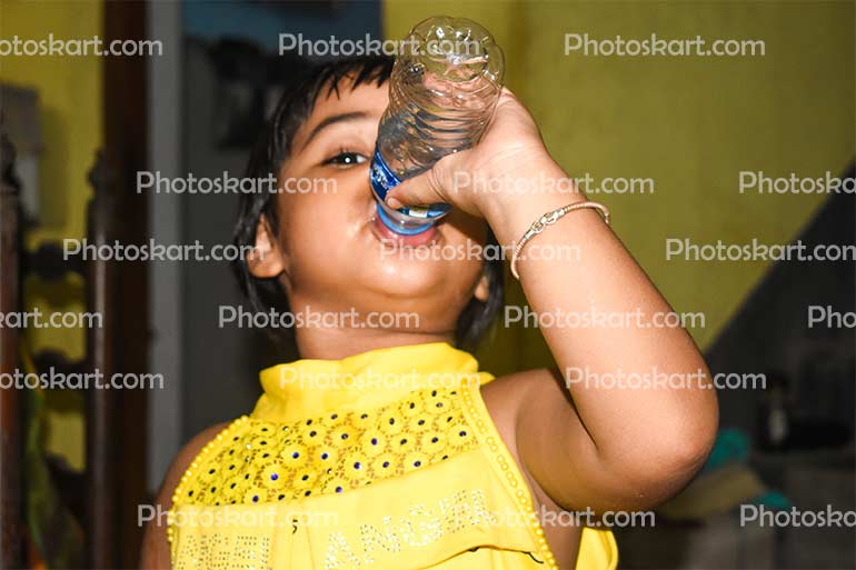 A Cute Child Drinking Water