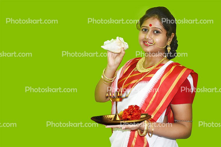 A Indian Young Lady Carry Puja Accessories