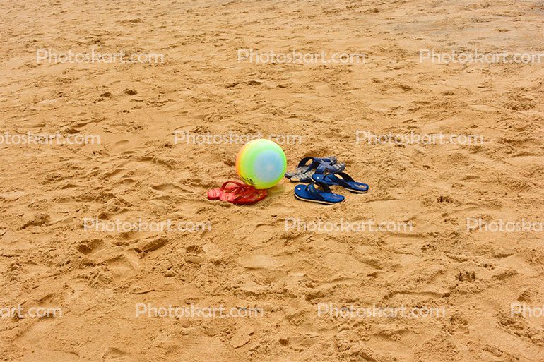 Ball And Shoes In A Sea Beach