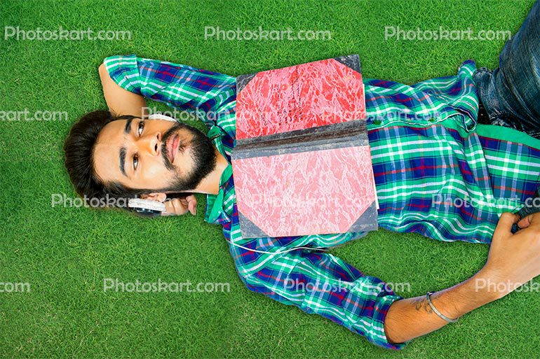 Young Boy Listening Song In Garden