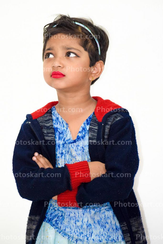 A Little Indian Girl Standing With Bothered
