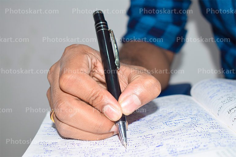 Closeup Hand Going To Write Something On Notebook