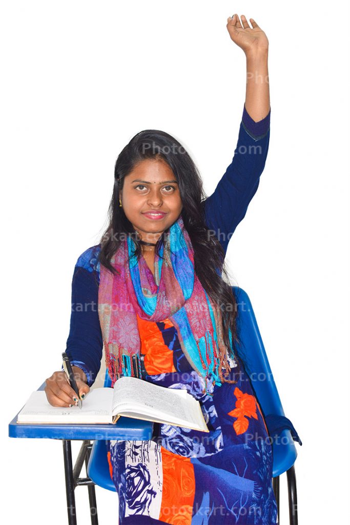 A Female Student Sitting On A Writing Chair And Raising Her Hand