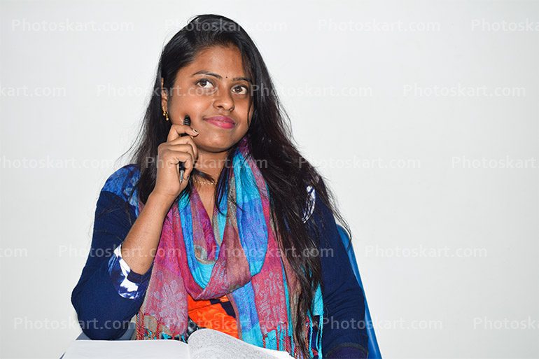 A Indian Female Student Sitting On A School Desk And Thinking