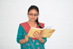 indian-college-girl-reading-note-book-stock-images
