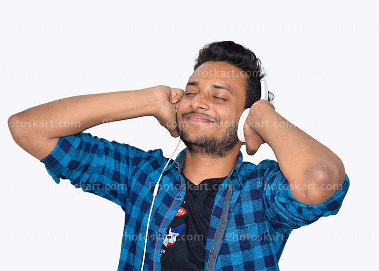 Smiling Boy Holding His Headphone And Listening Music