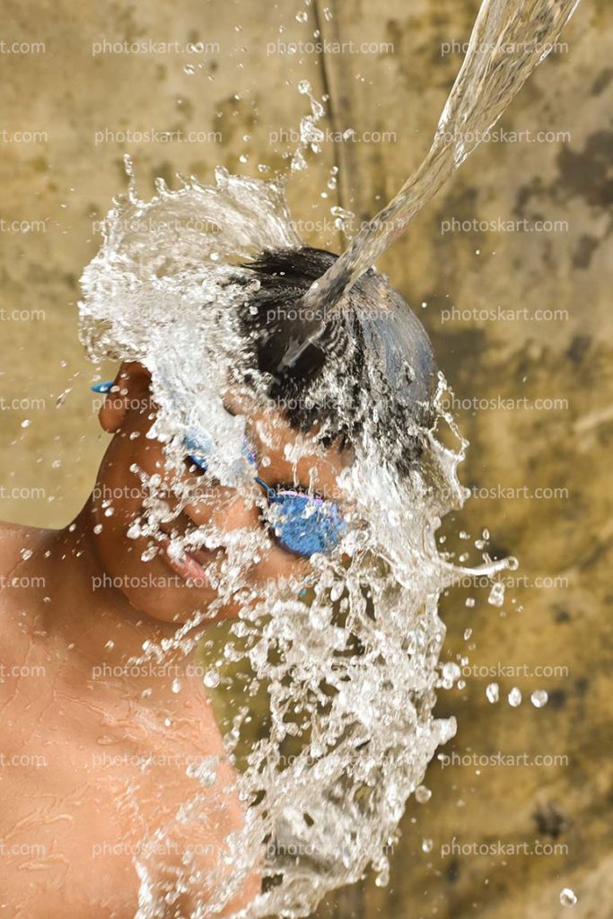 Indian Teen Boy Getting Splashed Water Stock Photo