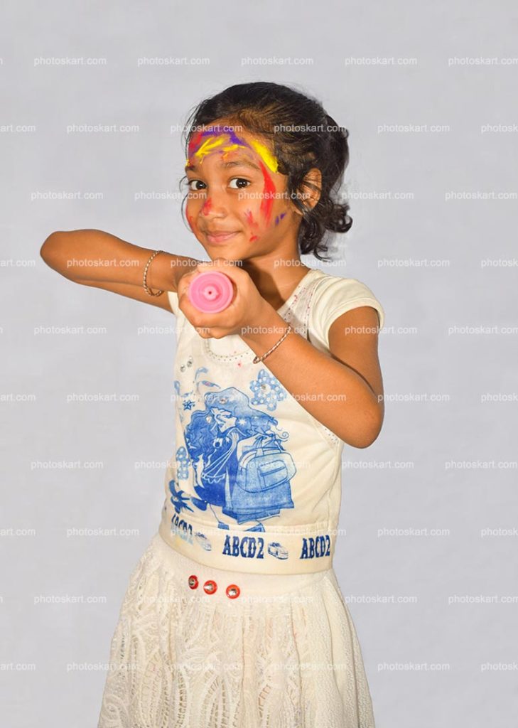 A Little Girl Holding A Pichkari Enjoying Holi Festival In India