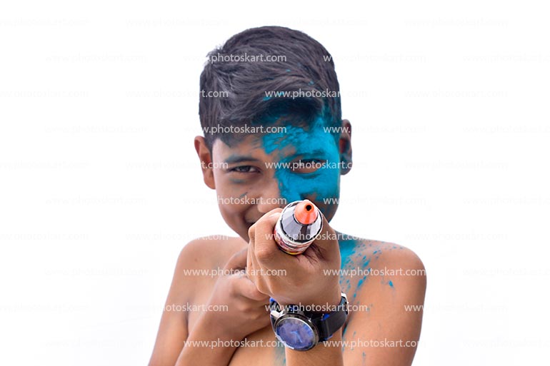 An Indian Boy Half Face Covered With Colours Hold A Pichkari