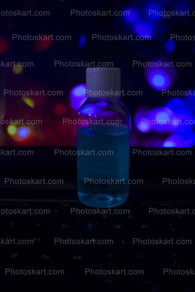 Dark Colorful Background Behind A Bottle