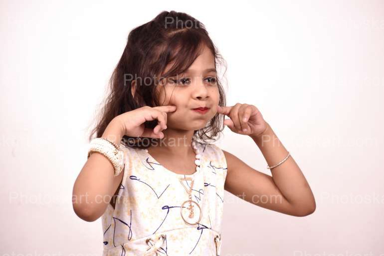 a Little Indian girl making funny face stock image | Photoskart