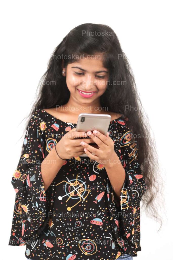 A Young Indian Girl Using Phone Stock Image