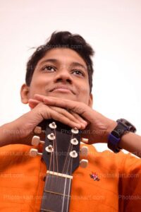 an-indian-boy-with-guiter-stock-photo