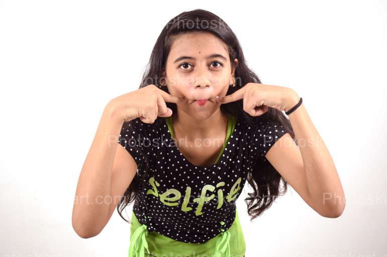 an indian girl making funny face stock image | Photoskart