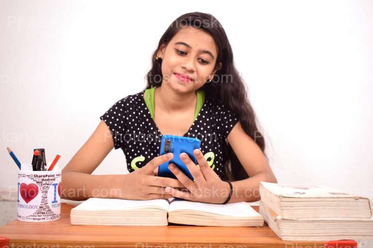An Indian Girl Using Phone During Study Time