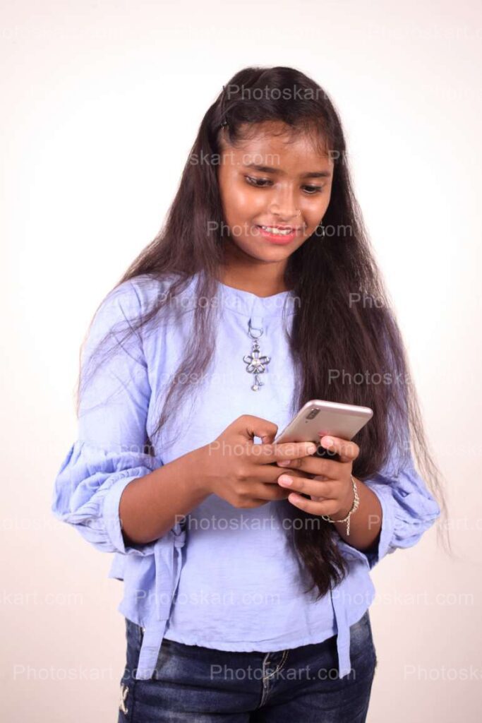 An Indian Standing Girl Busy With Mobile Phone
