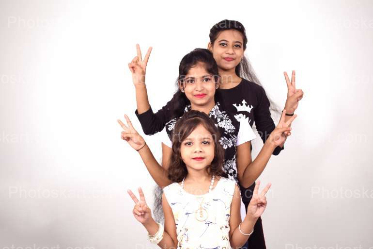 Three Indian Girl Doing Victory Gesture Royalty Free Image