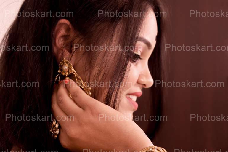 A Smiling Beautiful Indian Girl Hands On Earing Image