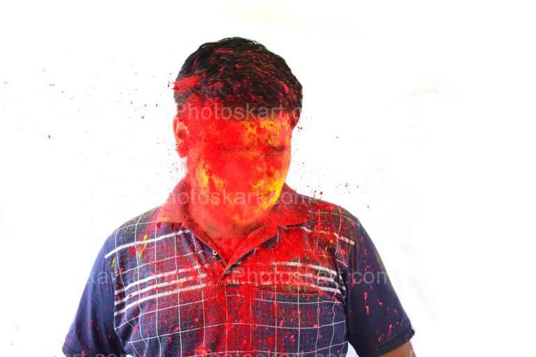 A Young Indian Boy Enjoying The Holi Festival With Coloured Powder Face Stock Photo