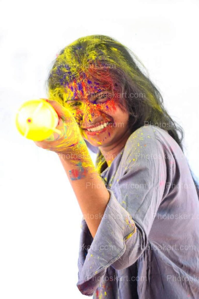 A Young Indian Girl Playing Holi With A Pichkari Stock Photo 2