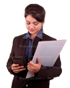an indian corporate women holding a file while checking her phone on other hand images