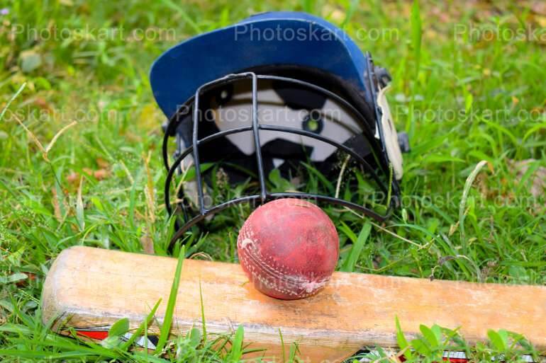 Cricket Helmet Ball And Bat In A Field Royalty Free Stock Image