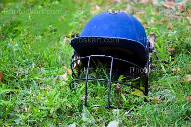 Cricket Helmet In A Field Royalty Free Stock Image