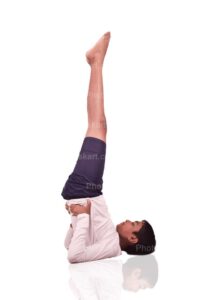 indian teenage boy doing sarvangasana stock image