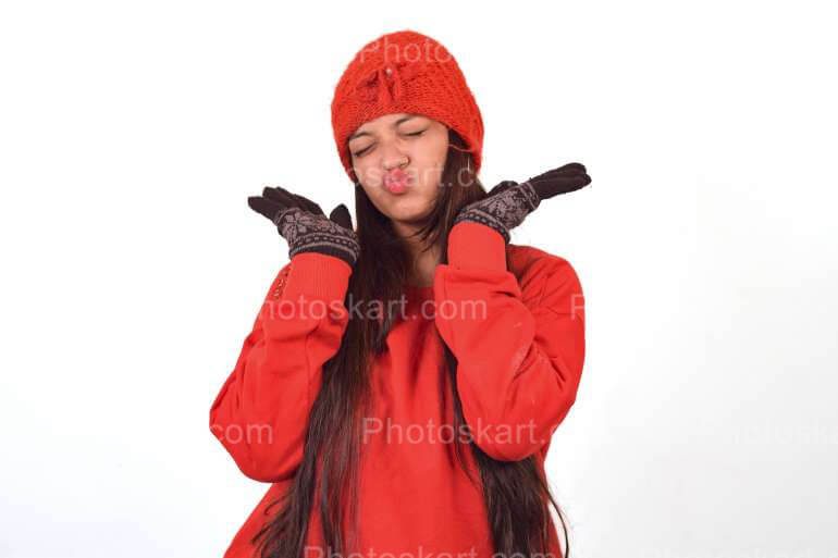 A Girl Funny Posing While Wearing Red Winter Cap