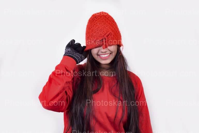 A Girl Hiding Her Face With Red Winter Cap