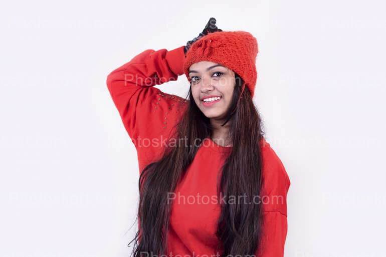 A Girl Posing While Red Winter Cloths