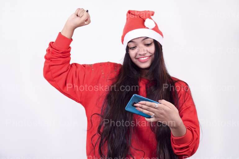 Indian Girl Cheering While Wearing Red Santa Cap