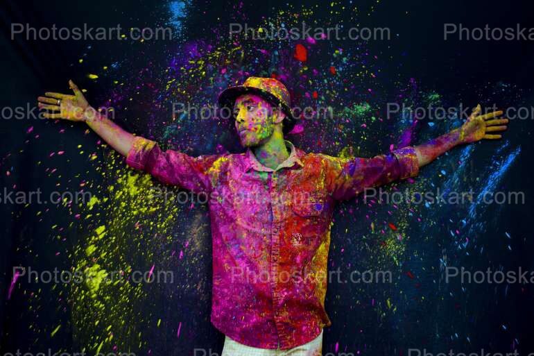 A Boy Hand Gesture With Full Of Holi Colors