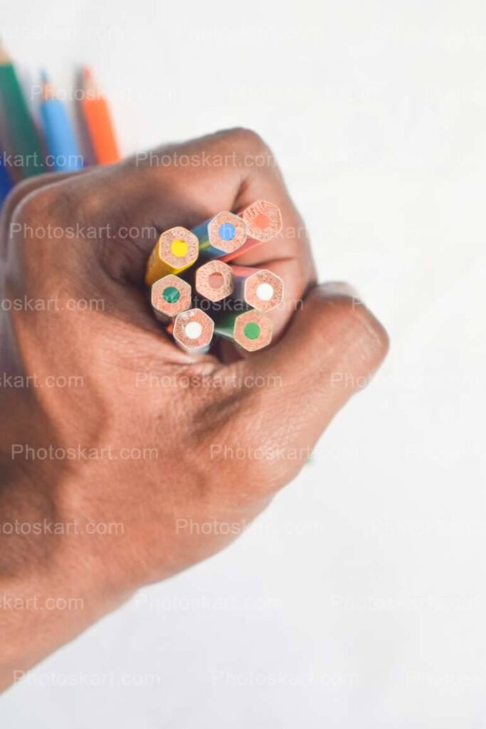 A Hand Holding Many Color Pencils Stock Images