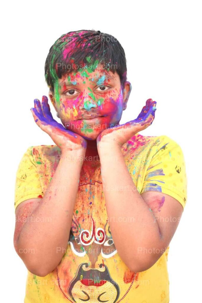 Cute Boy Posing In Holi With Coloful Face Stock Photo
