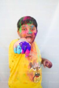 cute-indian-boy-posing-with-colorful-hand-punch