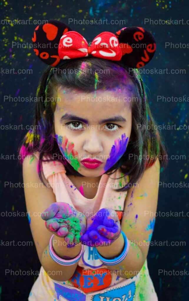 Cute Indian Gils Blowing Some Colors From Her Hand