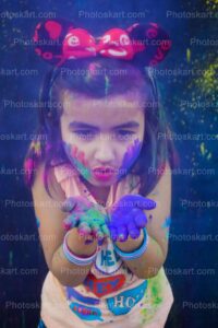 cute-indian-girl-blowing-blue-color-in-holi-festival