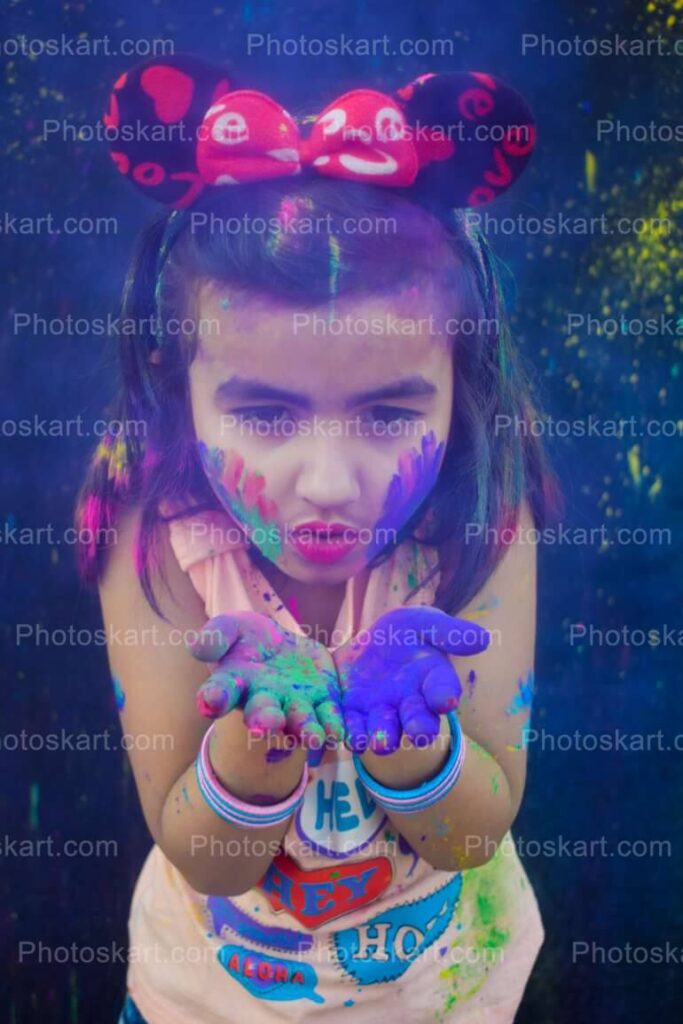 Cute Indian Girl Blowing Blue Color In Holi Festival