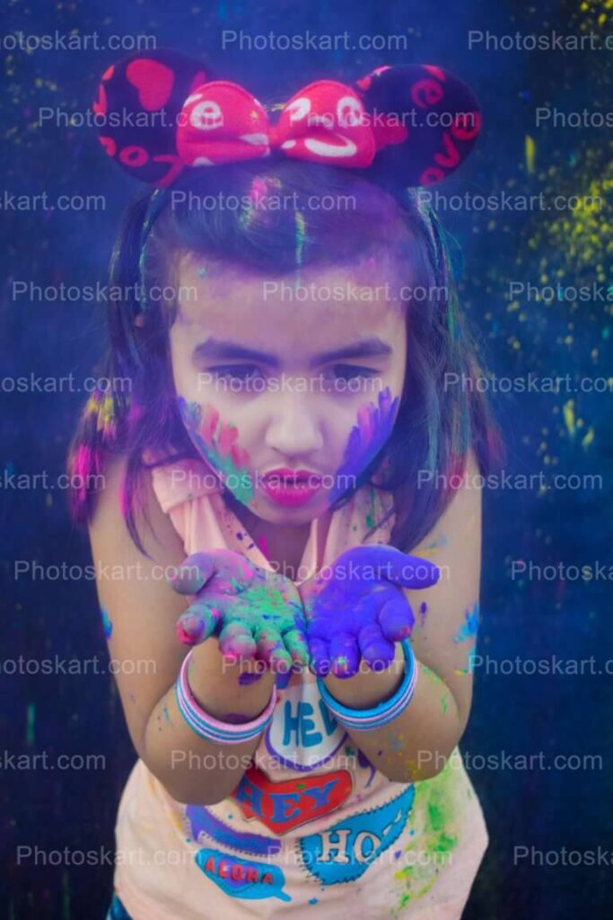 Cute Indian Girl Blowing Blue Color In Holi Festival