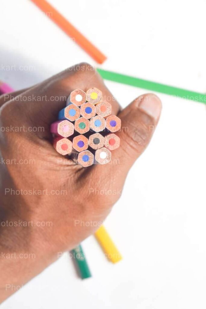 Hand Holding Colorful Pencils