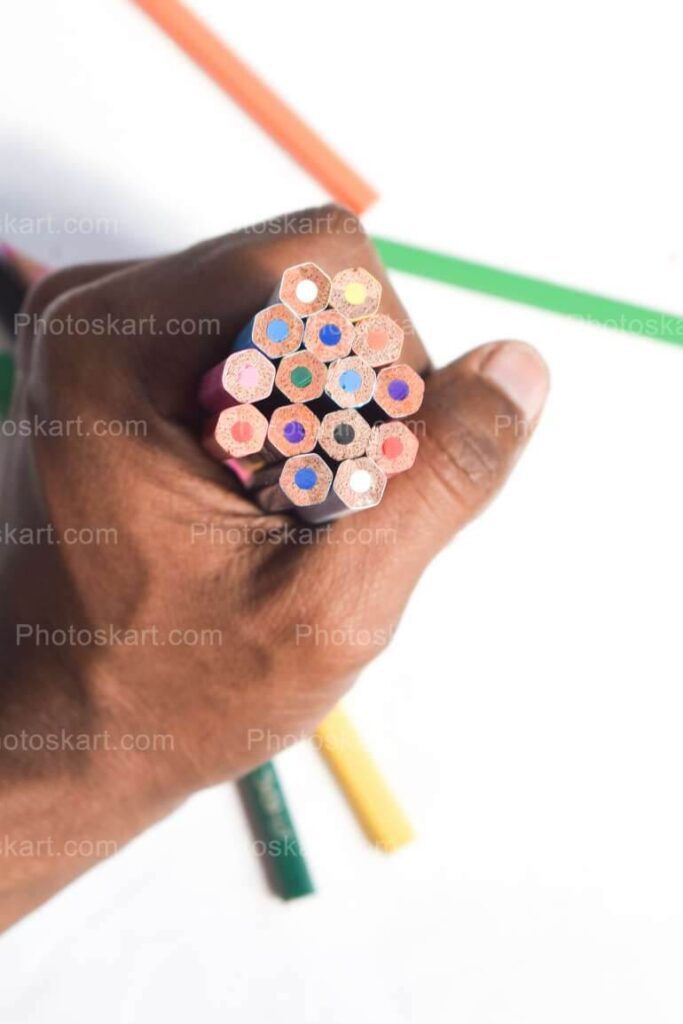 Hand Holding Multicolored Pencils