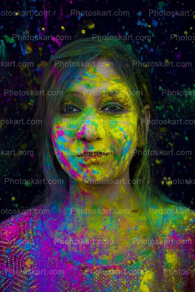 Portrait Of A Girl Face Full Of Color On Holi