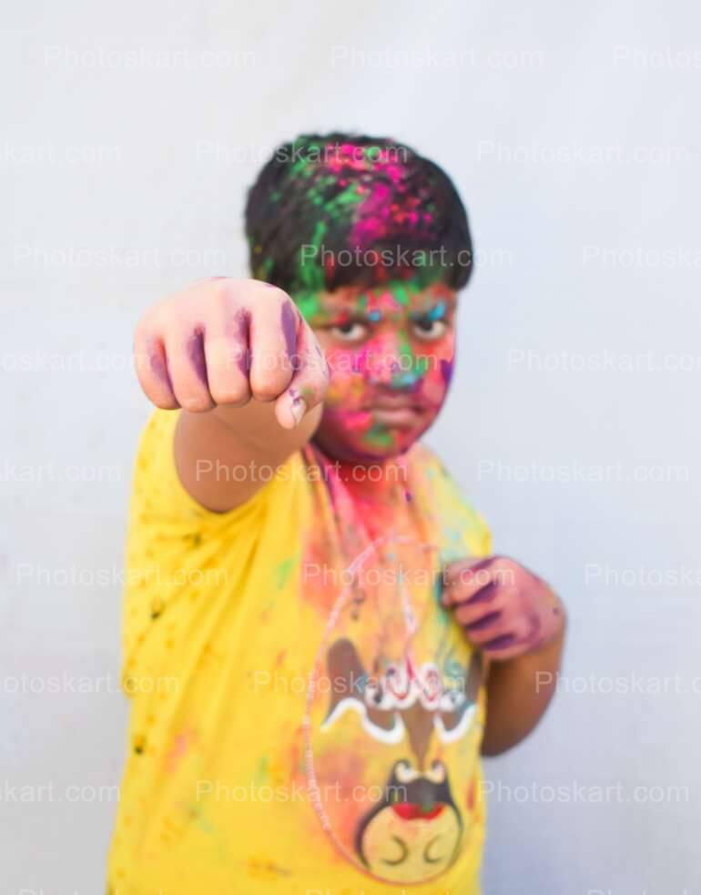 Smart Indian Boy Punch With Colorful Face