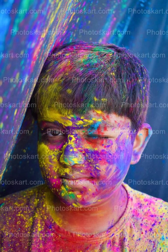 Smart Indian Boy Wink With Colorful Face In Holi