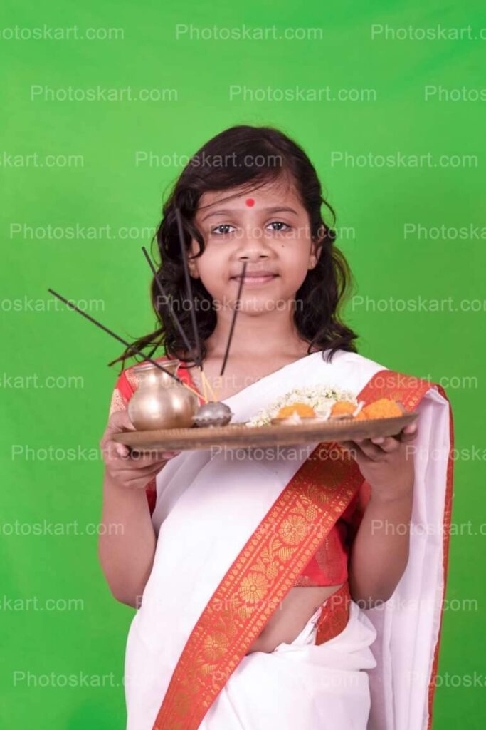 Cute Hindu Girl Holding Puja Thali For Puja Occasion Stock Photo