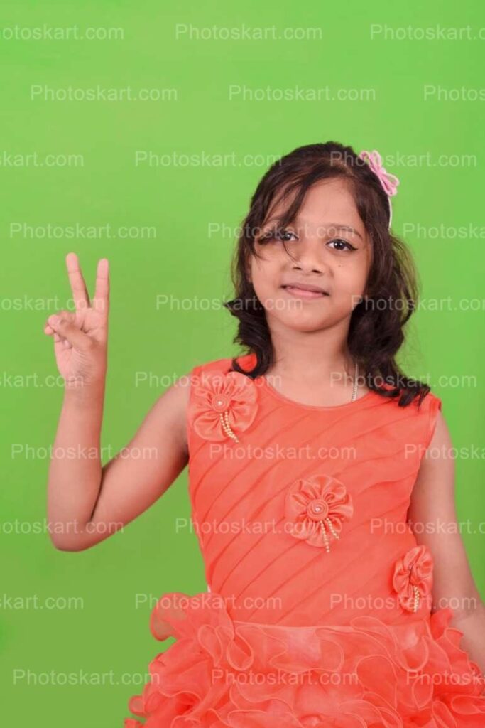 Cute Indian Girl Posing Victory Sign With Her Fingers